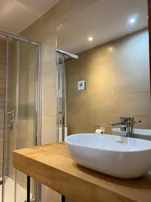 a bathroom with a large white sink and a shower at Amazing sea and Sagrada Familia views homey apartment in Barcelona