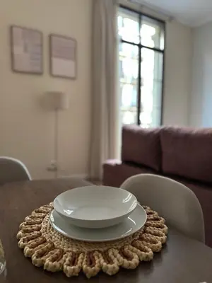 a plate on a table in a living room at Anais Apartments by gaiarooms in Barcelona