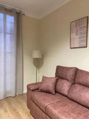 a living room with a couch and a window at Anais Apartments by gaiarooms in Barcelona