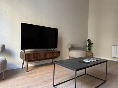 a living room with a flat screen tv on a table at Anais Apartments by gaiarooms in Barcelona