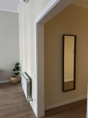 a hallway with a mirror and a radiator in a room at Anais Apartments by gaiarooms in Barcelona