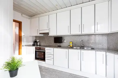a white kitchen with white cabinets and a sink at Stay U-nique Apartments Sant Antoni II in Barcelona