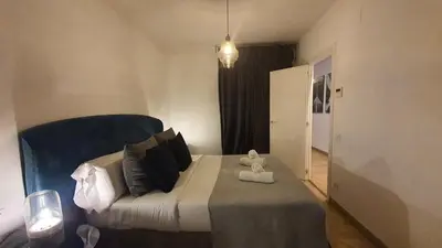 a bedroom with a bed with a teddy bear on it at Barrio Gotico Apartments Escudellers in Barcelona