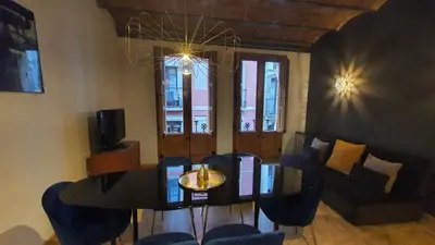 a living room with a table and a couch at Barrio Gotico Apartments Escudellers in Barcelona