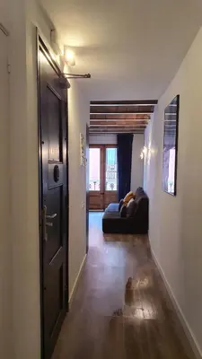 a living room with a couch and a door at Barrio Gotico Apartments Escudellers in Barcelona
