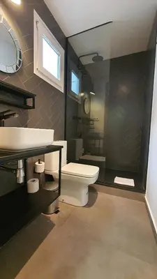 a bathroom with a toilet and a sink and a mirror at Barrio Gotico Apartments Escudellers in Barcelona