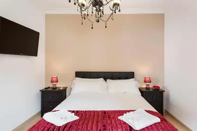 a bedroom with a large bed with two night stands at Apartment Eduardo in Barcelona