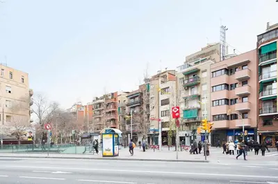 a city street with people walking on the sidewalk and buildings at Apartment Eduardo in Barcelona