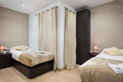 a bedroom with two beds with curtains in it at Apartment Eduardo in Barcelona