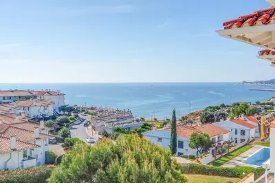 a view of a town with the ocean in the background at Seaside Cozy Apartment by Hello Homes Sitges in Sitges
