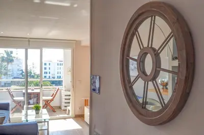 a large wooden clock on a wall in a living room at Seaside Cozy Apartment by Hello Homes Sitges in Sitges