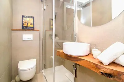 a bathroom with a toilet and a sink and a shower at Sitges Spaces Garden Paradise 3 bedroom, 3 bathroom, huge PRIVATE garden-terrace, pool- sleeps up to 8 in Sitges