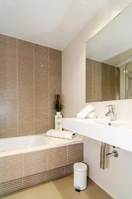 a bathroom with a tub and a sink and a mirror at Sitges Spaces Garden Paradise 3 bedroom, 3 bathroom, huge PRIVATE garden-terrace, pool- sleeps up to 8 in Sitges