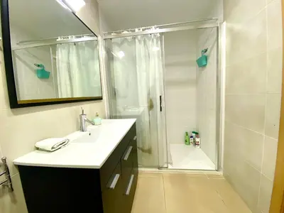 a bathroom with a shower and a white sink at Terraza Relajante Galvani in Terrassa