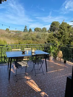 a ping pong table sitting on a patio at Charming apartment in a duplex with garden & balcony in Cunit