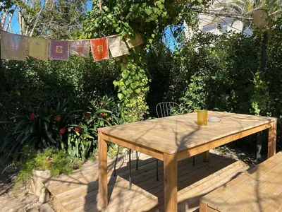 a wooden table with a cup on top of it at Charming apartment in a duplex with garden & balcony in Cunit