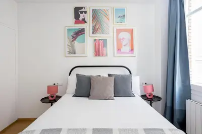 a bedroom with a white bed with two side tables at Livefull 2bdr In Trendy Gracia in Barcelona