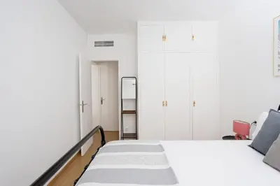a white bedroom with a bed and a ladder at Livefull 2bdr In Trendy Gracia in Barcelona