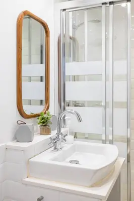 a bathroom with a sink and a mirror at Livefull 2bdr In Trendy Gracia in Barcelona