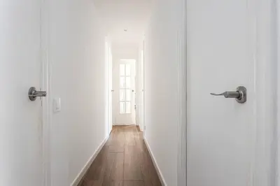an empty hallway with two doors and a wooden floor at Stylish&bright Close To Subway in Esplugues de Llobregat