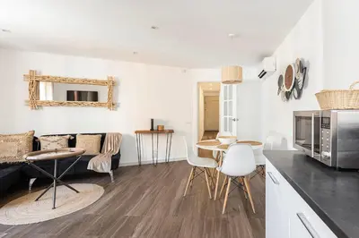 a kitchen and living room with a table and chairs at Stylish&bright Close To Subway in Esplugues de Llobregat