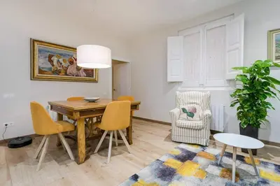 a living room with a wooden table and chairs at Lovely Designed House Connected To Center in Cornellà de Llobregat