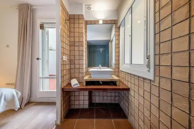a bathroom with a sink and a mirror at Caliu Apartments Barcelona - Fira in Hospitalet de Llobregat