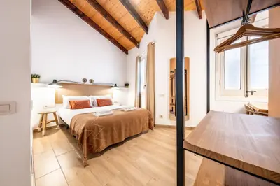 a bedroom with a bed and a desk in a room at Caliu Apartments Barcelona - Fira in Hospitalet de Llobregat