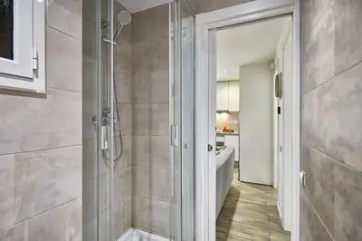 a shower with a glass door in a bathroom at BBarcelona Sant Pau Flat in Barcelona