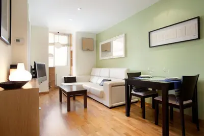 a living room with a couch and a table at rentBCN Gracia Jardinets in Barcelona