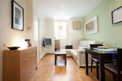 a living room with a couch and a table at rentBCN Gracia Jardinets in Barcelona