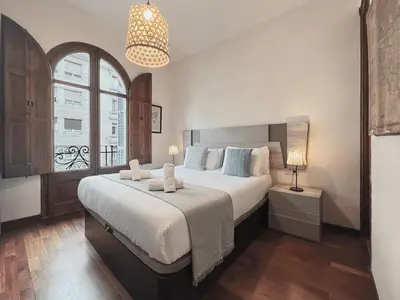 a bedroom with a large bed and a window at Stay U-nique Apartments Industria II in Barcelona