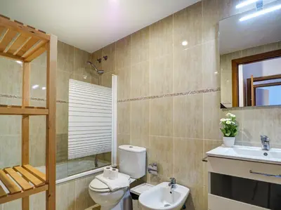 a bathroom with a toilet and a sink at Molins Apartment by Hello Homes Sitges in Sitges