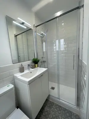 a white bathroom with a sink and a shower at Apartamento Kemacu in Barcelona