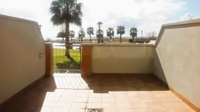 a balcony with a view of a palm tree at Onze - primera línea de mar con piscina in Cubelles