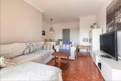 a living room with a couch and a tv at Apartment Muralla in Vilassar de Mar
