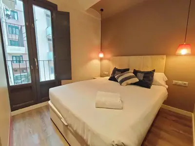 a bedroom with a large white bed with two pillows at Montserrat Apartments by gaiarooms in Barcelona