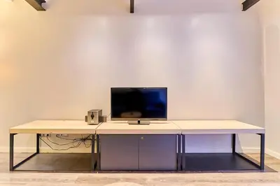 a desk with a computer monitor on top of it at Montserrat Apartments by gaiarooms in Barcelona