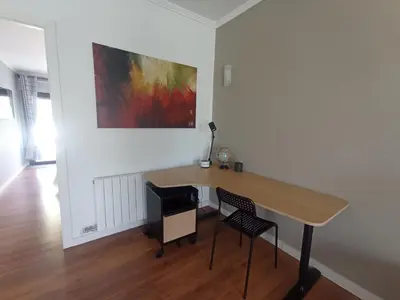 a room with a table and two chairs and a painting at Edard's Great House in Castelldefels