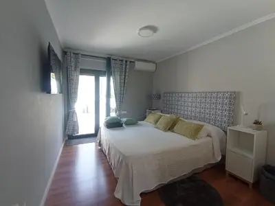 a bedroom with a bed with pillows and a window at Edard's Great House in Castelldefels