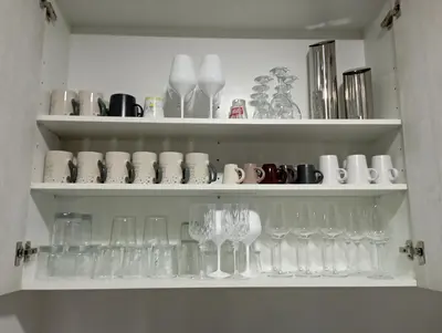 a shelf filled with wine glasses and other items at Edard's Great House in Castelldefels