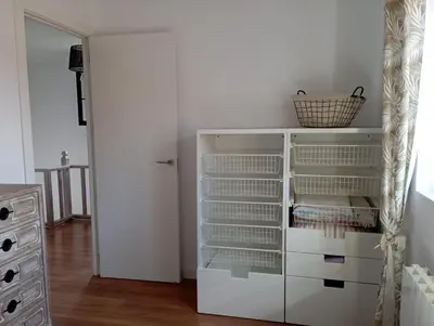 a white closet with white drawers and a mirror at Edard's Great House in Castelldefels