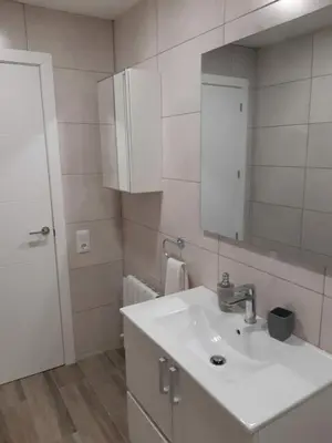 a white bathroom with a sink and a mirror at Edard's Great House in Castelldefels