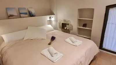 a white bed with two white towels on it at Opening Doors Vilassar. Family house Beach & Relax in Vilassar de Mar