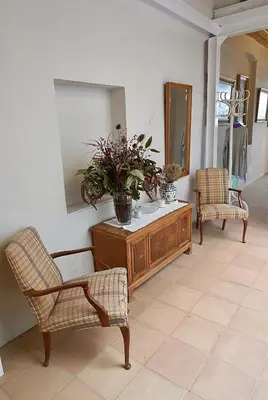 a living room with two chairs and a dresser with a mirror at Opening Doors Vilassar. Family house Beach & Relax in Vilassar de Mar
