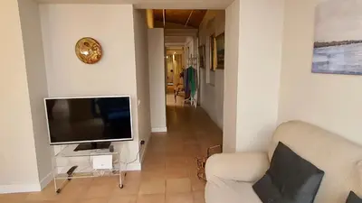 a living room with a television and a couch at Opening Doors Vilassar. Family house Beach & Relax in Vilassar de Mar