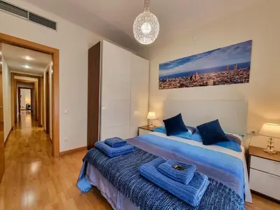 a bedroom with a bed with blue towels on it at Apartment PICNIC SANTS in Barcelona
