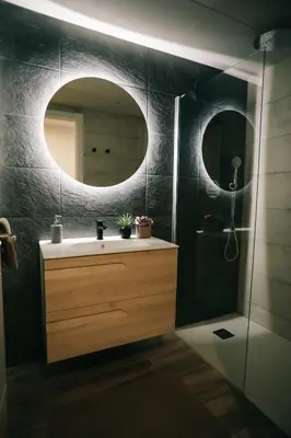 a bathroom with a sink and a mirror at RCE Apartments Calella, brand new next to the beach. in Calella