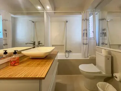 a bathroom with a sink and a toilet and a shower at Ocean Spirit House by Hello Homes Sitges in Sitges