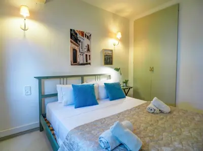 a bedroom with two beds with blue pillows at Ocean Spirit House by Hello Homes Sitges in Sitges